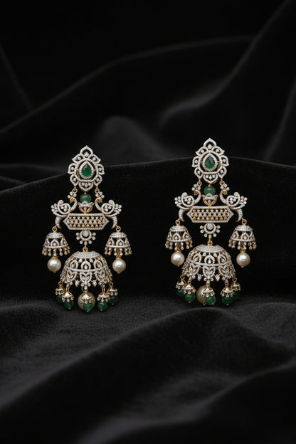 Ornate earrings with pearls and gemstones on a red background