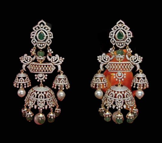 Ornate earrings with pearls and gemstones on a red background