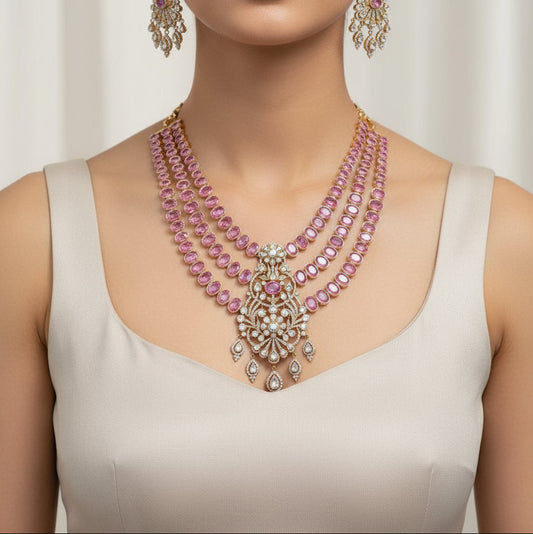Jewelry set with pink gemstones and gold accents on a black background