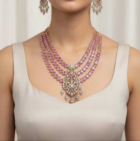 Jewelry set with pink gemstones and gold accents on a black background